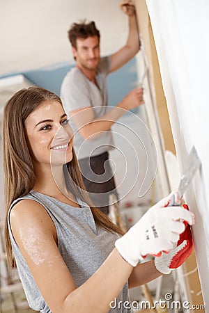 Attractive woman renovating house smiling Stock Photo