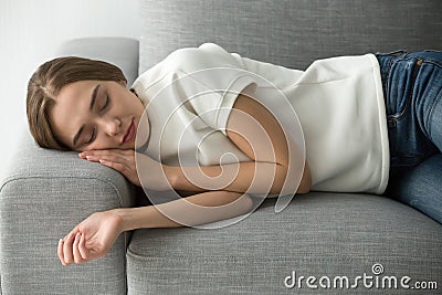 Attractive woman sleeping on comfortable soft sofa Stock Photo