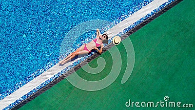 Attractive woman tourist in bikini sunbathes in scorching hot tropical summer. Sexy young woman sleeps on the edge of the crystal Stock Photo