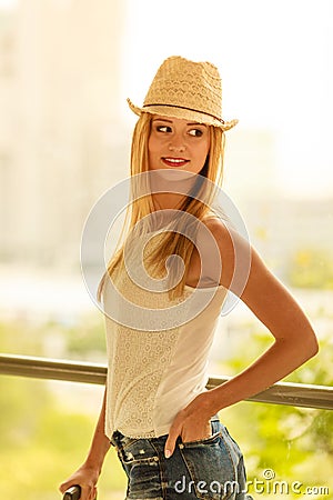Attractive woman wearing sun hat and white top Stock Photo