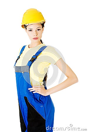 Attractive woman wears work clothes and helmet. Stock Photo