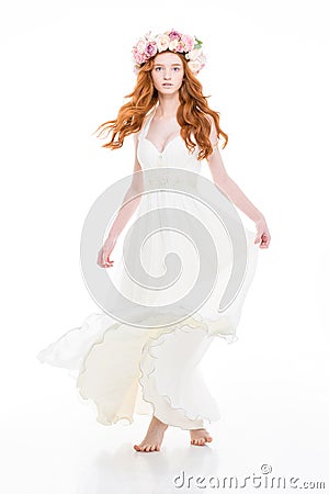 Attractive woman in white dress and beautiful wreath of roses Stock Photo