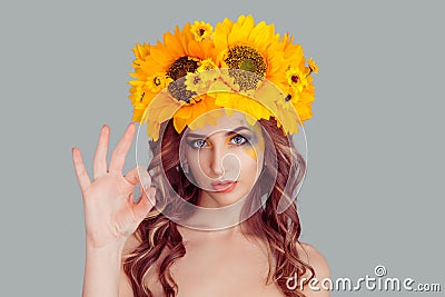 Woman with floral headband showing ok sign Stock Photo