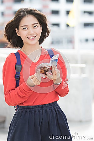 Attractive young asian student traveling outdoor smiling face wi Stock Photo