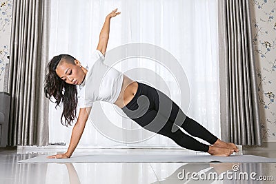 Young asian woman exercising and doing yoga Stock Photo