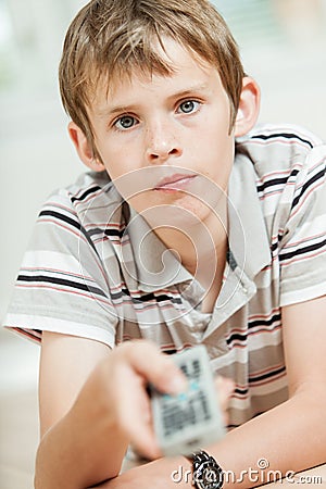 Attractive young boy using a remote control Stock Photo