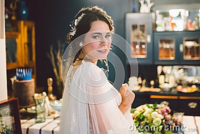 Attractive young bride before wedding ceremony. Bride`s Preparations. Wedding Morning. Charming bride in white wedding dress at Stock Photo