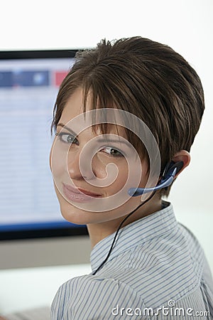 Attractive Young Businesswoman with a Headset Stock Photo