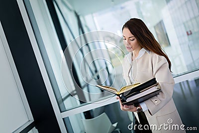 Attractive young businesswoman looking at files at office Stock Photo