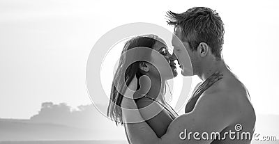 Attractive young couple enjoying a romantic kiss Stock Photo