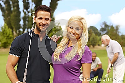 Attractive young couple ready for golfing Stock Photo