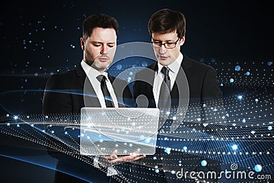 Attractive young european businessmen with laptop standing on abstract glowing blue metaverse background. Digital world, teamwork Stock Photo