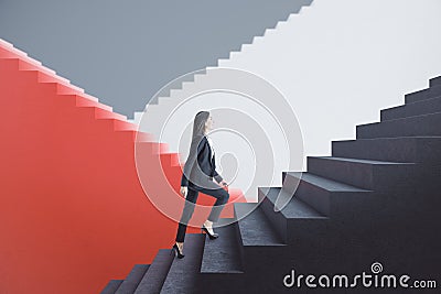 Attractive young european businesswoman walking on red and concrete staircase with mock up place. Success, finance and career Stock Photo