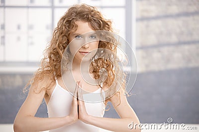 Attractive young female doing yoga exercise Stock Photo