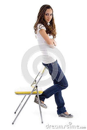 Attractive young female standing with support Stock Photo