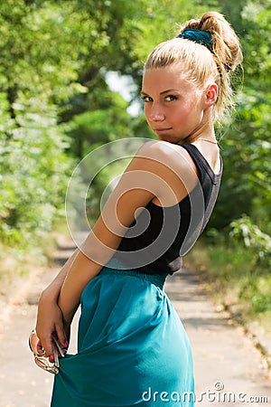 Attractive young girl posing in green park Stock Photo