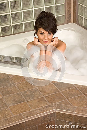 Attractive young gorges woman taking Bubble bath Stock Photo