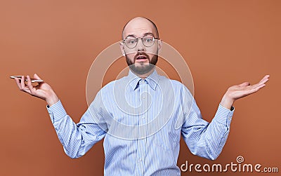 Surprised young guy in a shirt and phone in his hand Stock Photo