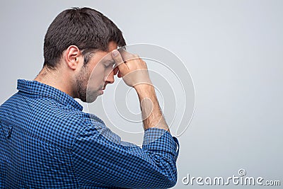 Attractive young man feels pain in his head Stock Photo