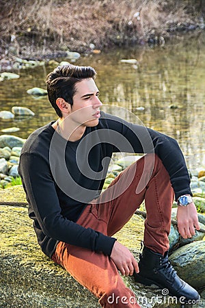 Attractive young man outdoor in nature, at river Stock Photo