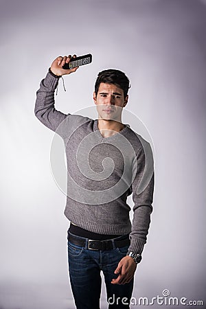 Attractive young man throwing away remote control Stock Photo