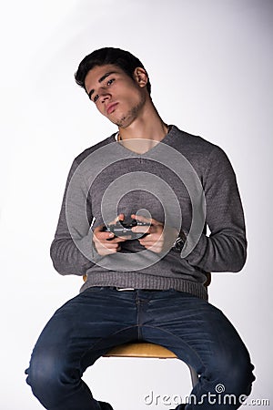 Attractive young man using joystick or joypad for videogames Stock Photo