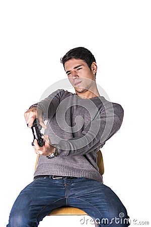 Attractive young man using joystick or joypad for videogames Stock Photo