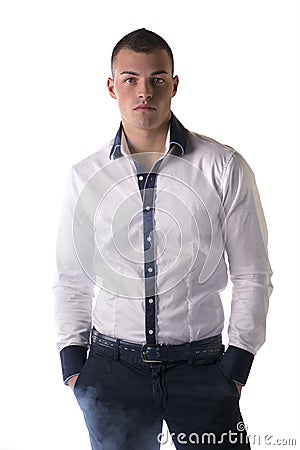 Attractive young man with white shirt, hands in pockets Stock Photo