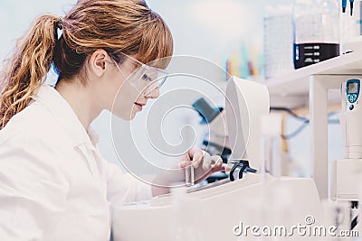 Attractive young scientist pipetting. Stock Photo