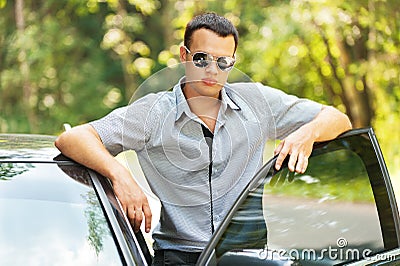 Attractive young serious man car Stock Photo