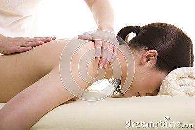 Attractive young woman being massaged Stock Photo