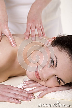 Attractive young woman being massaged Stock Photo