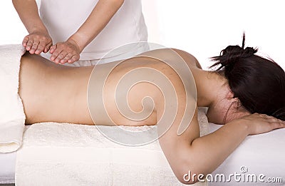 Attractive young woman being massaged Stock Photo