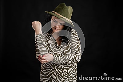 Attractive young woman dressed casually has painful feelings in right elbow Stock Photo