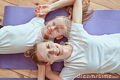 Attractive young woman and her little charming daughter are having fun at home together. Sincere smiles and tenderness Stock Photo