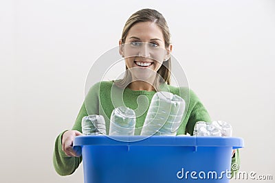 Attractive Young Woman Holding a Blue Recycle Bin Stock Photo