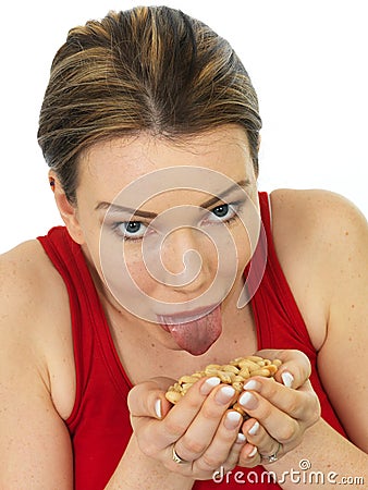 Attractive Young Woman Holding A Handful of Salted Roasted Peanu Stock Photo