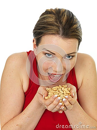 Attractive Young Woman Holding A Handful of Salted Roasted Peanu Stock Photo