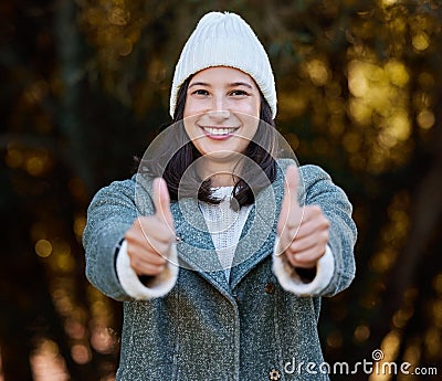 Im ready for the winter season. an attractive young woman standing alone outside and showing a thumbs up. Stock Photo