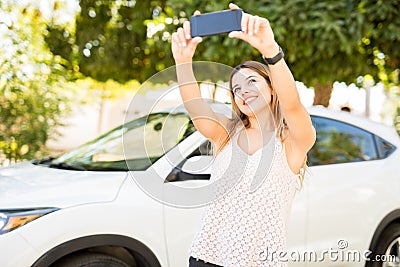 Woman taking selfiew with her new car Stock Photo