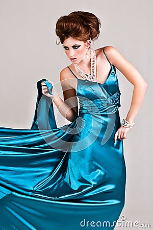 Attractive Young Woman Wearing A Blue Satin Dress Stock Attractive Young Woman Wearing A Blue Satin Dress Stock