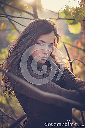 Young woman winter portrait in forest at sunset Stock Photo