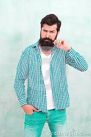 Attractiveness concept. Masculinity and male beauty. Hipster with beard and mustache wear shirt. Well groomed guy Stock Photo