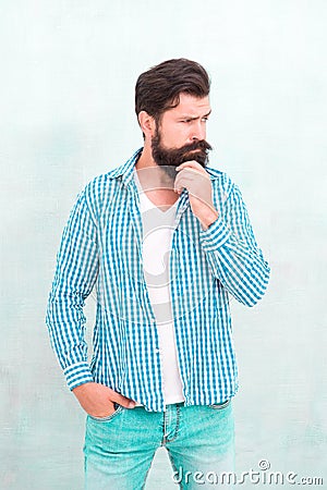Attractiveness concept. Well groomed guy. Brutal handsome hipster man grey wall background. Bearded man trendy hipster Stock Photo