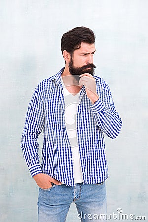 Attractiveness concept. Well groomed guy. Brutal handsome hipster man grey wall background. Bearded man trendy hipster Stock Photo