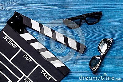Attributes of film director. Movie clapperboard and sunglasses on blue wooden table background top view Stock Photo