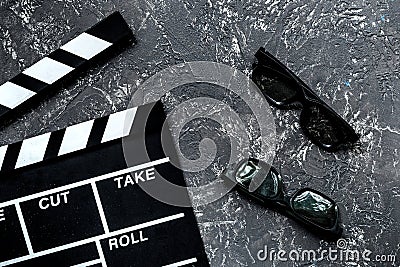 Attributes of film director. Movie clapperboard and sunglasses on grey stone table background top view Stock Photo