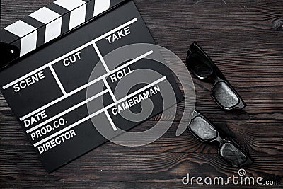 Attributes of film director. Movie clapperboard and sunglasses on wooden table background top view Stock Photo