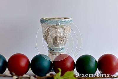 Easter eggs stacked in a row and a lamp on the table Stock Photo