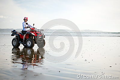 ATV driver on the beach Stock Photo